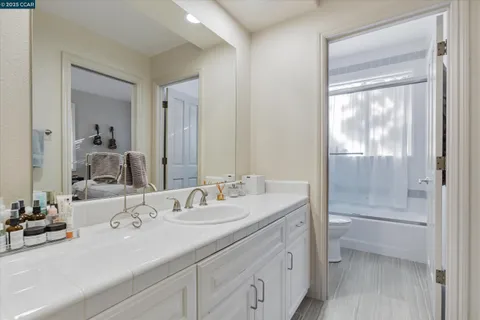 a bathroom with a sink double vanity and a mirror