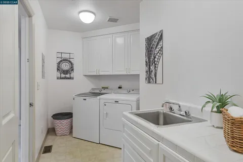 a kitchen with a sink stove and cabinets
