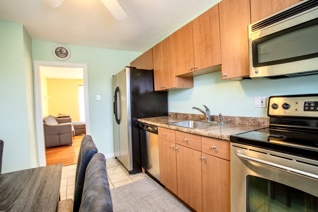 15 Westgate Road, Unit 6 Chestnut Hill, MA 02467 - Photo 1 of 20 a kitchen with stainless steel appliances granite countertop a sink stove and refrigerator