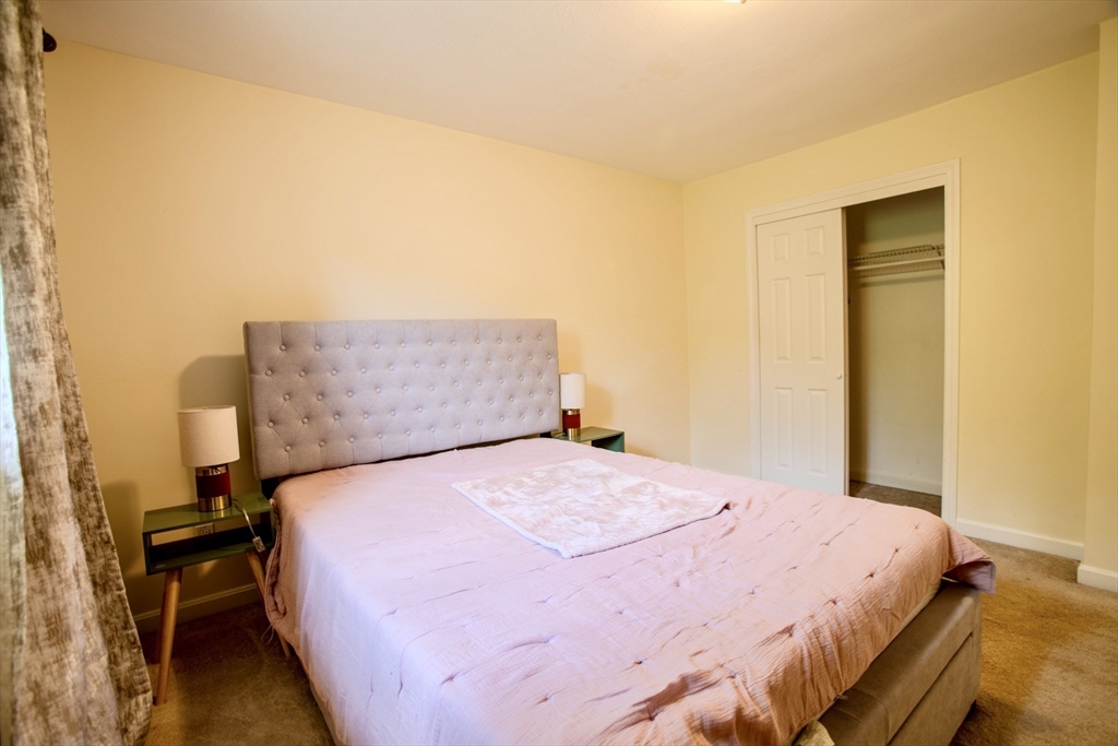 15 Westgate Road, Unit 6 Chestnut Hill, MA 02467 - Photo 12 of 20 a bedroom with a bed and wooden floor