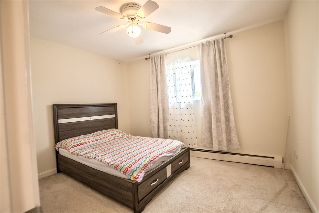 15 Westgate Road, Unit 6 Chestnut Hill, MA 02467 - Photo 14 of 20 a bedroom with a bed and window