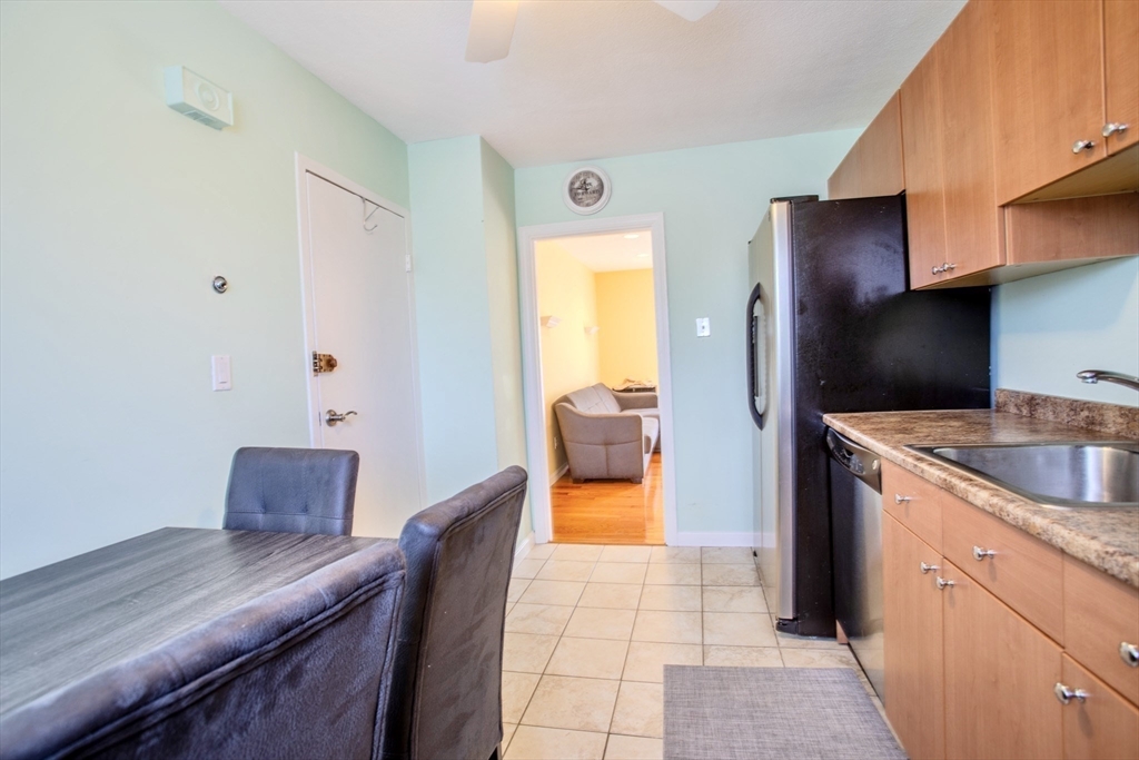 15 Westgate Road, Unit 6 Chestnut Hill, MA 02467 - Photo 2 of 20 a kitchen with stainless steel appliances granite countertop a sink and a refrigerator