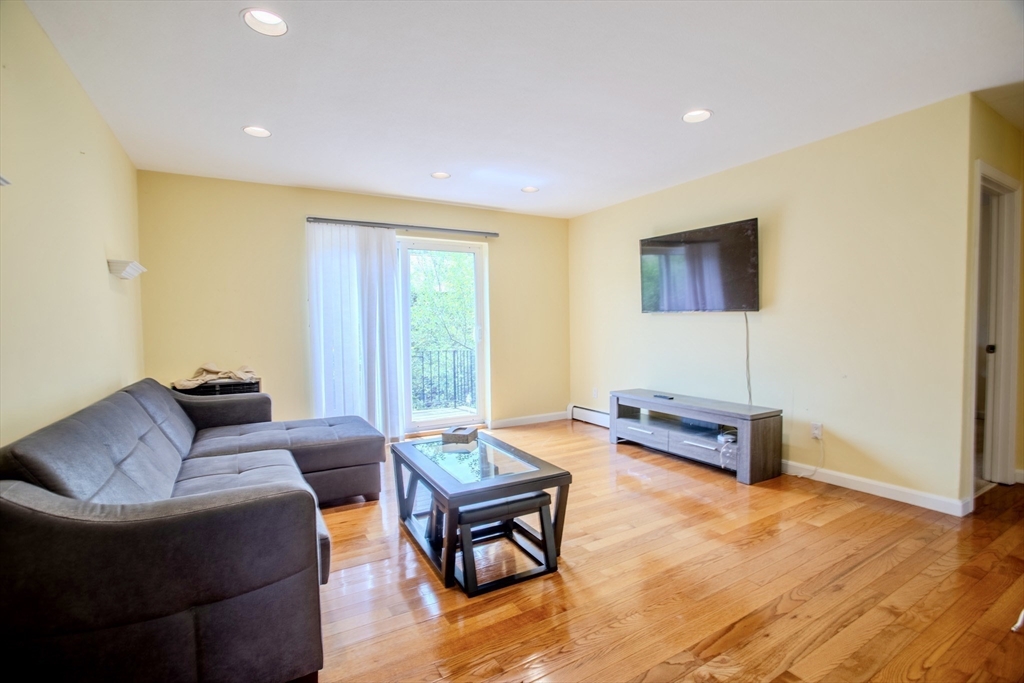 15 Westgate Road, Unit 6 Chestnut Hill, MA 02467 - Photo 3 of 20 a living room with furniture and a flat screen tv