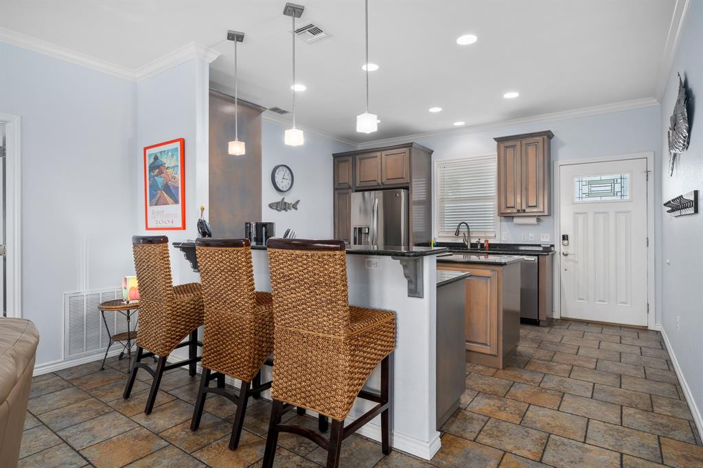 515 Copano Cove Road Rockport, TX 78382 - Photo 11 of 39 a kitchen with granite countertop a sink cabinets and stainless steel appliances
