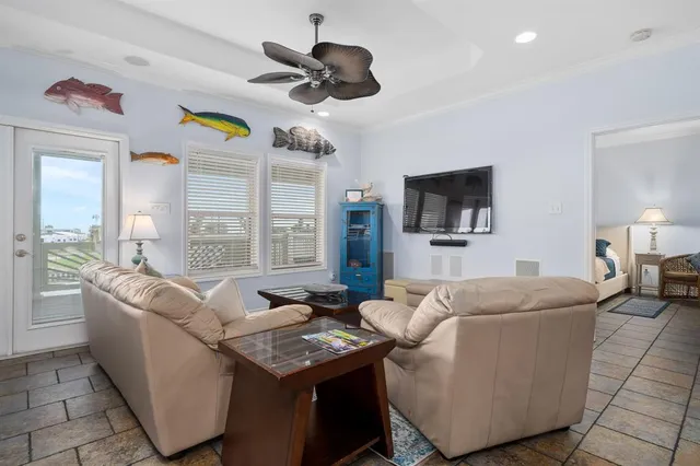 a living room with furniture a flat screen tv and a window