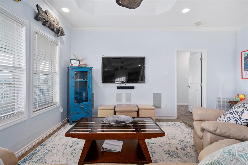 515 Copano Cove Road Rockport, TX 78382 - Photo 13 of 39 a living room with furniture a flat screen tv and a window