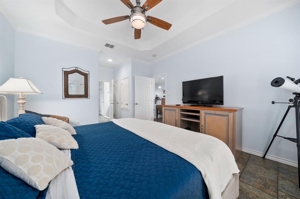 515 Copano Cove Road Rockport, TX 78382 - Photo 17 of 39 a bedroom with a bed and a flat screen tv