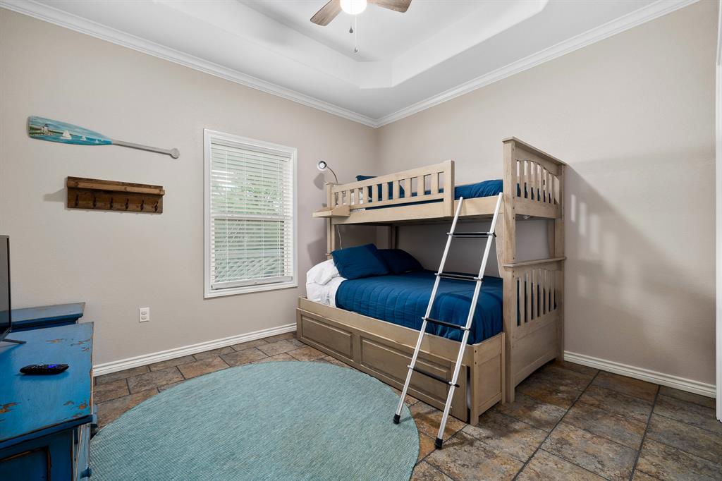 515 Copano Cove Road Rockport, TX 78382 - Photo 22 of 39 a bedroom with furniture and a window