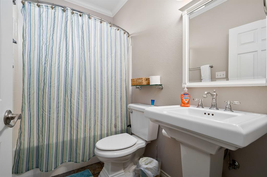 515 Copano Cove Road Rockport, TX 78382 - Photo 23 of 39 a bathroom with a sink a toilet and a mirror