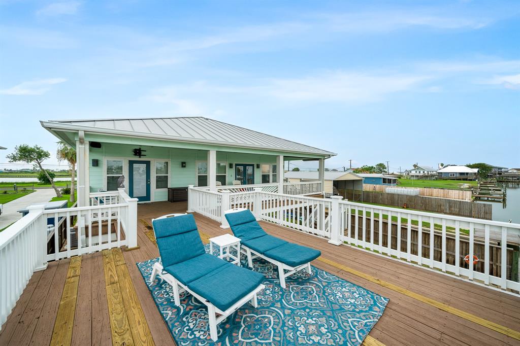515 Copano Cove Road Rockport, TX 78382 - Photo 28 of 39 a view of a house with a deck and furniture
