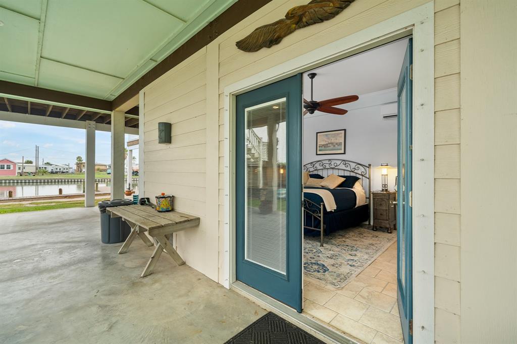 515 Copano Cove Road Rockport, TX 78382 - Photo 29 of 39 a bedroom with furniture and a gate