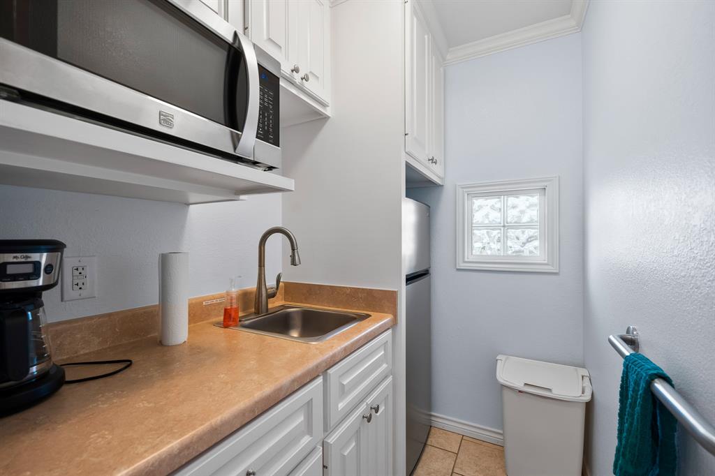 515 Copano Cove Road Rockport, TX 78382 - Photo 32 of 39 a kitchen with a sink and a toilet
