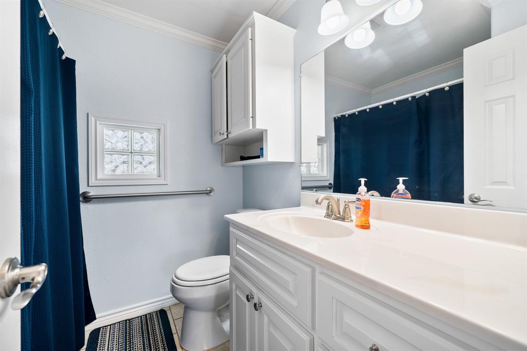 515 Copano Cove Road Rockport, TX 78382 - Photo 33 of 39 a bathroom with a sink a toilet and a mirror