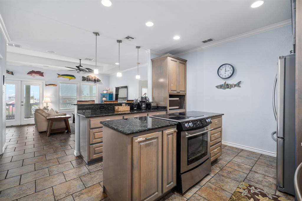515 Copano Cove Road Rockport, TX 78382 - Photo 8 of 39 a kitchen with stainless steel appliances granite countertop a stove and a sink