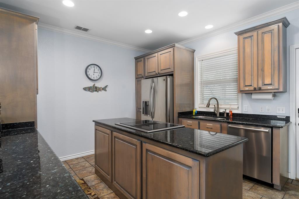 515 Copano Cove Road Rockport, TX 78382 - Photo 9 of 39 a kitchen with stainless steel appliances granite countertop a sink and a refrigerator