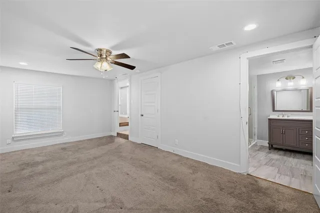 a view of an empty room with a bathroom