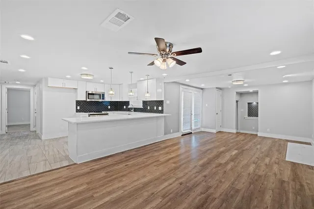 a view of kitchen with refrigerator microwave and stove