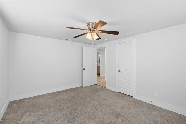 a view of a room with a fan and a fan