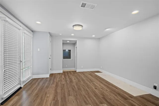 wooden floor in an empty room with a window