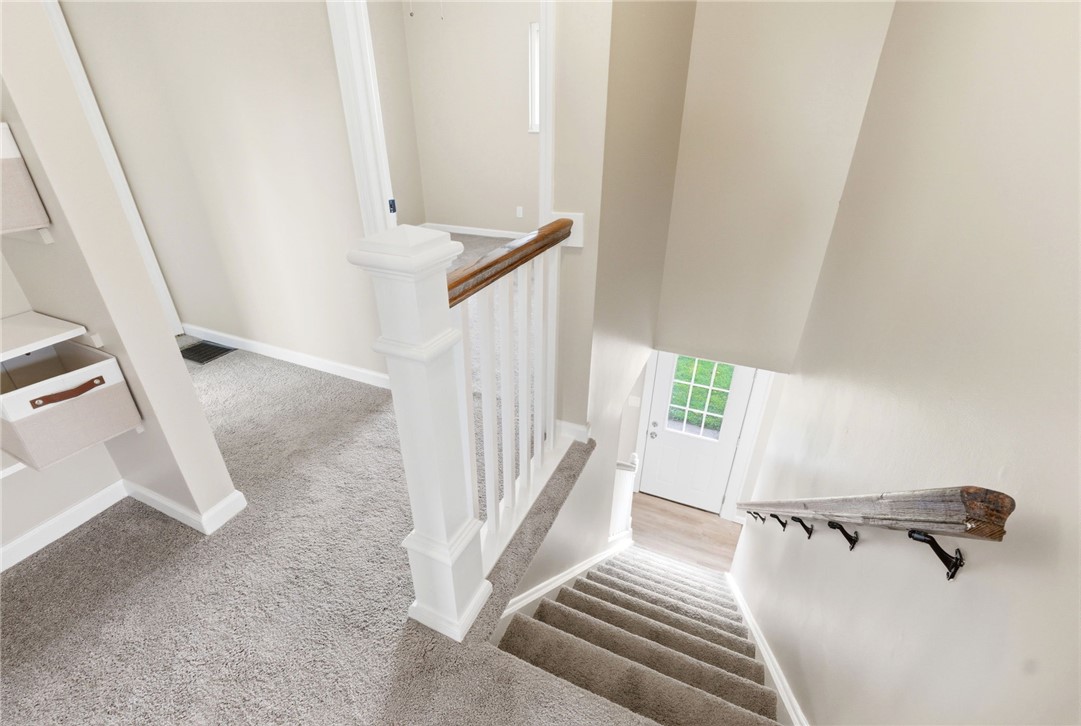 40 Woods Road Springboro, OH 45066 - Photo 37 of 57 This inviting home features carpeted stairs with a white wooden railing leading to a bright entry.