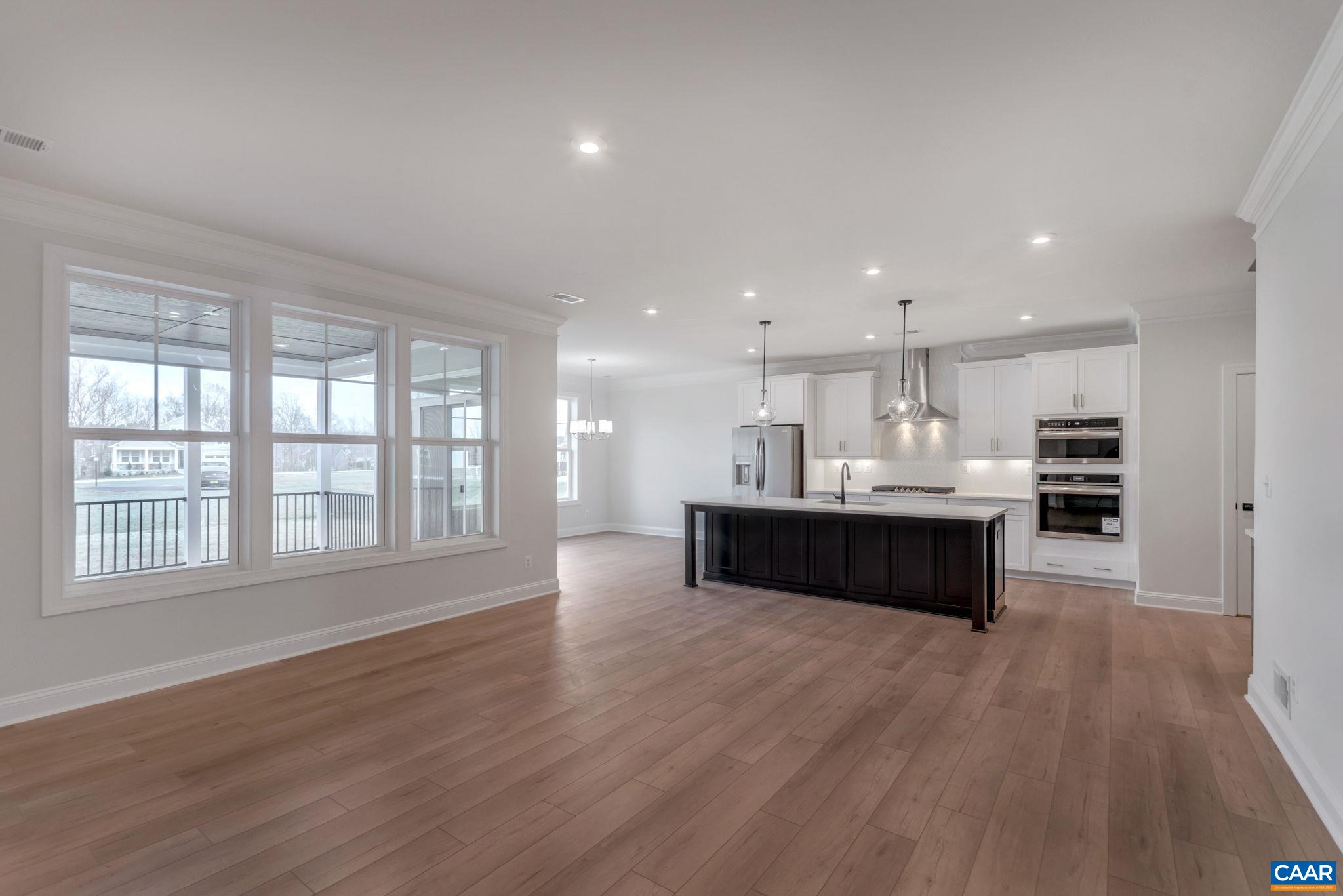 3012 Miranda Crossing Charlottesville, VA 22901 - Photo 13 of 57 a living room with stainless steel appliances kitchen island wooden cabinets and a wooden floor