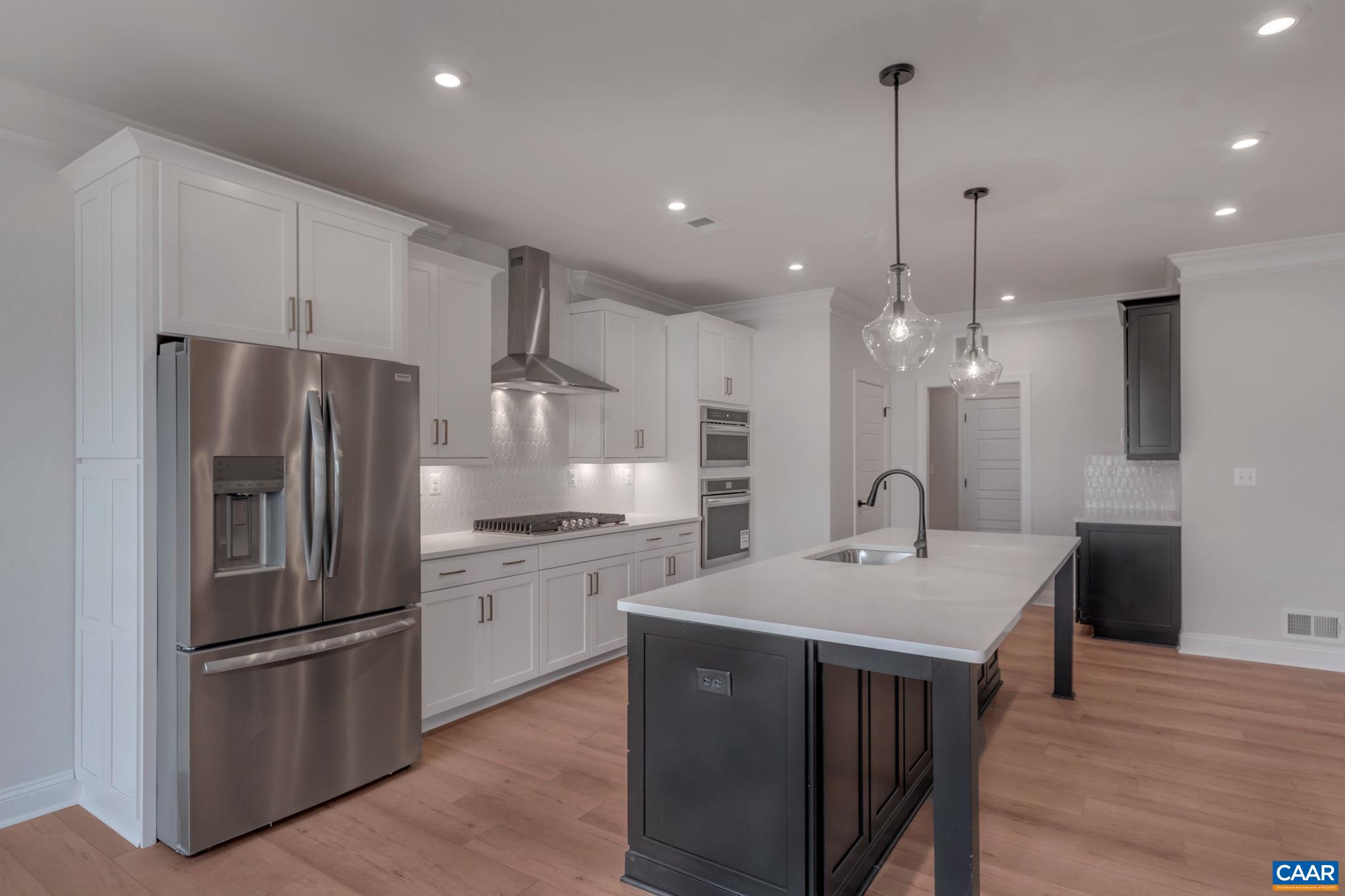 3012 Miranda Crossing Charlottesville, VA 22901 - Photo 16 of 57 a kitchen with kitchen island a sink stainless steel appliances and cabinets