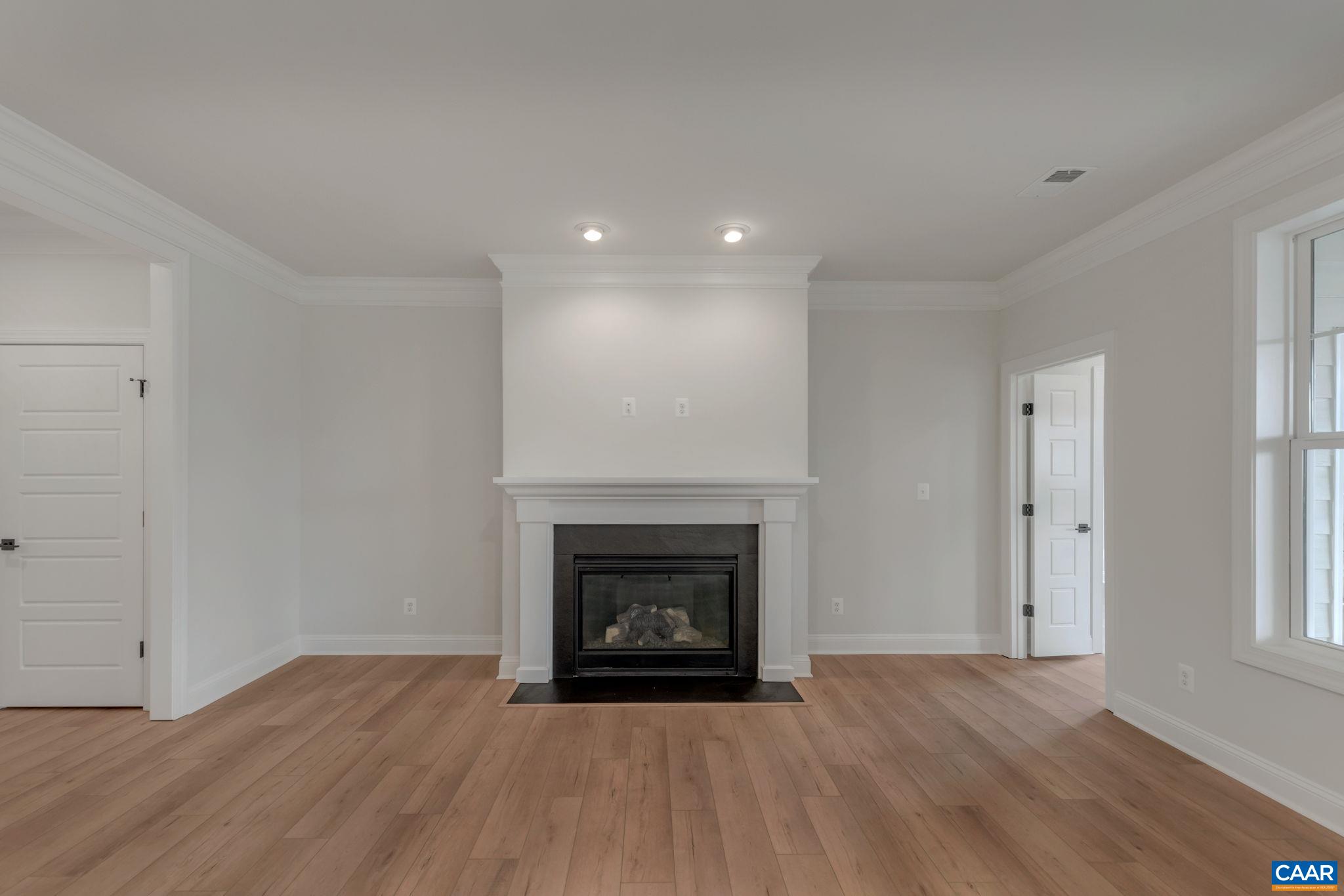 3012 Miranda Crossing Charlottesville, VA 22901 - Photo 24 of 57 a view of an empty room with wooden floor fireplace and a window