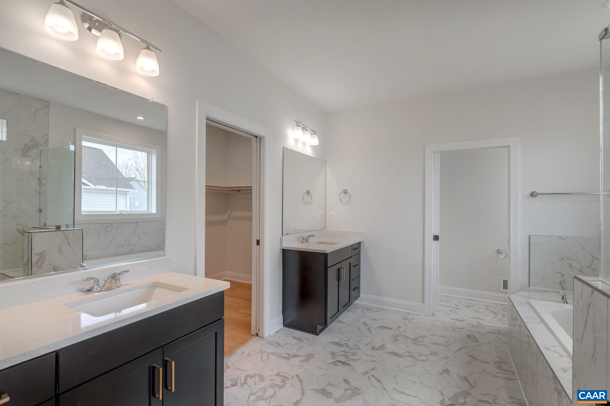 3012 Miranda Crossing Charlottesville, VA 22901 - Photo 31 of 57 a spacious bathroom with a bathtub sink and mirror