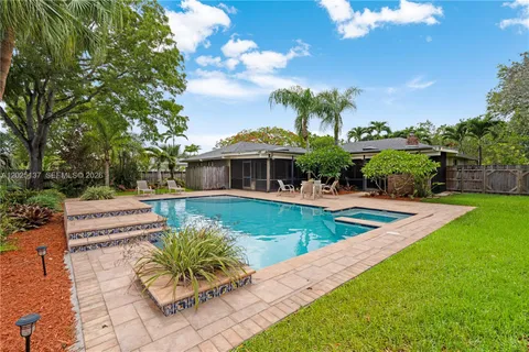 a view of swimming pool with sitting area and garden