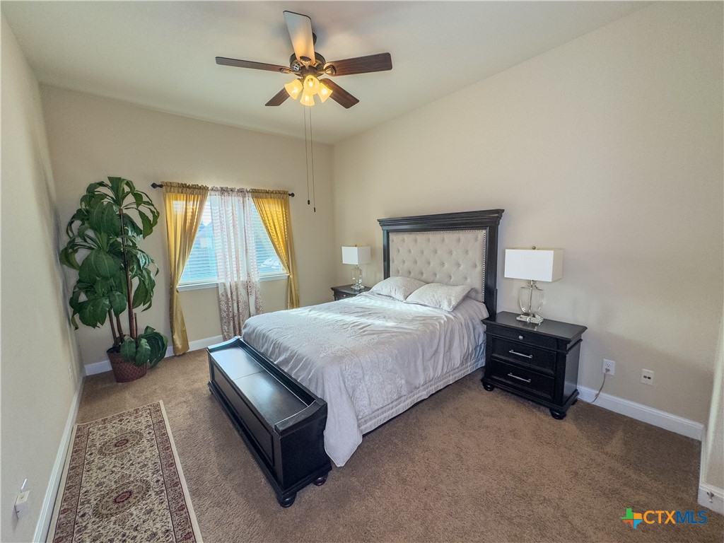 809 Alpino Cibolo, TX 78108 - Photo 15 of 29 a bedroom with a bed and a chandelier