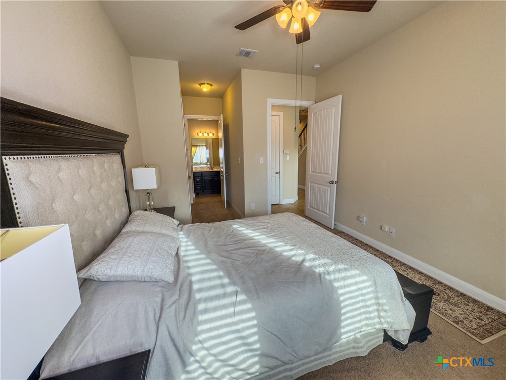 809 Alpino Cibolo, TX 78108 - Photo 16 of 29 a bedroom with a bed and a chandelier