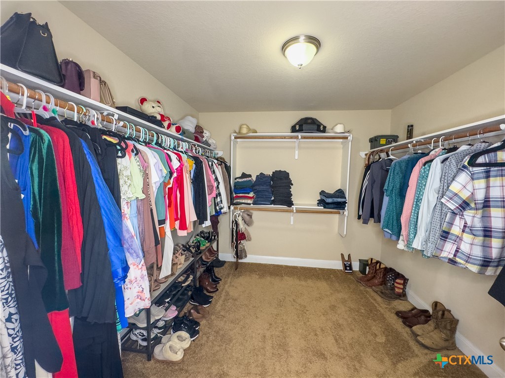 809 Alpino Cibolo, TX 78108 - Photo 22 of 29 a view of walk in closet with clothes and shoes