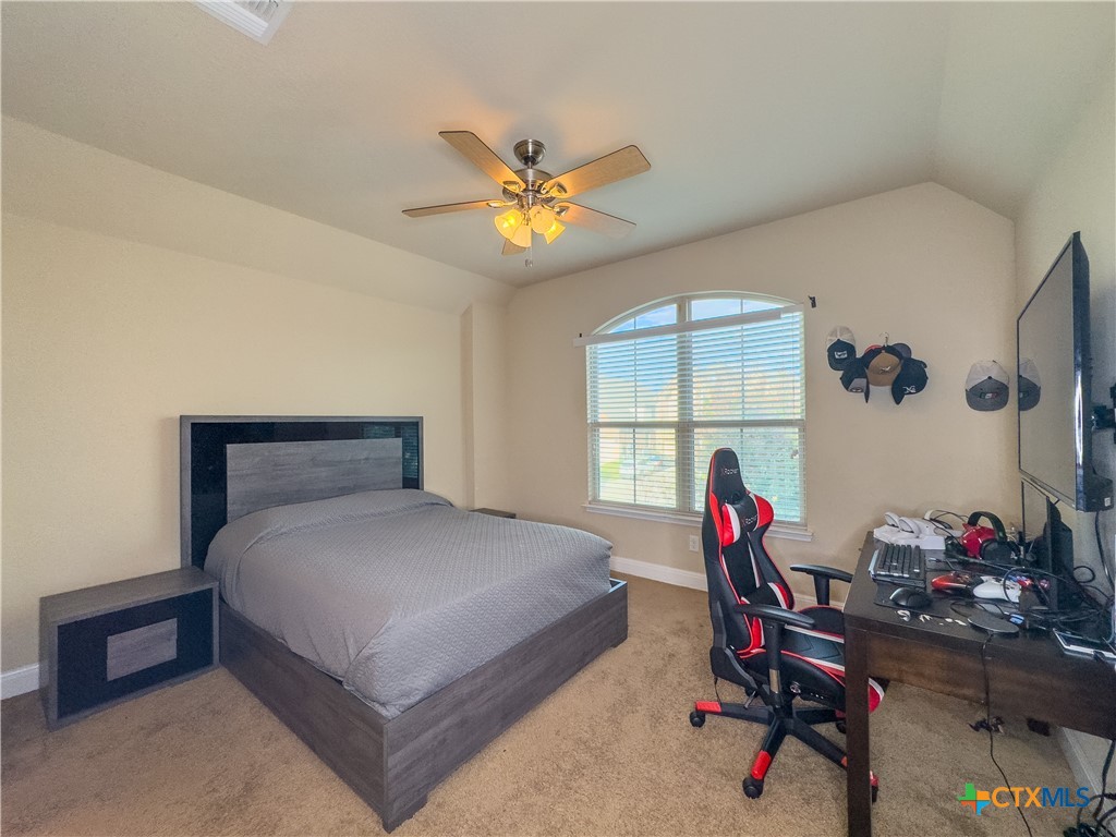809 Alpino Cibolo, TX 78108 - Photo 25 of 29 a bedroom with a bed and a window