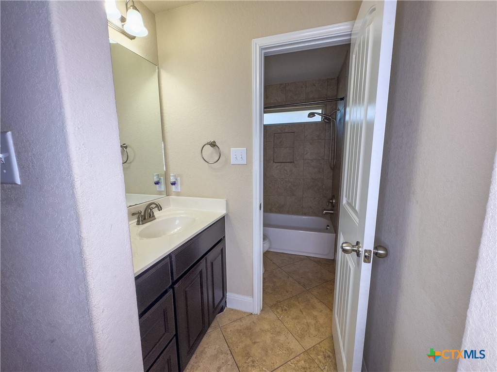 809 Alpino Cibolo, TX 78108 - Photo 26 of 29 a bathroom with a sink a mirror and a shower