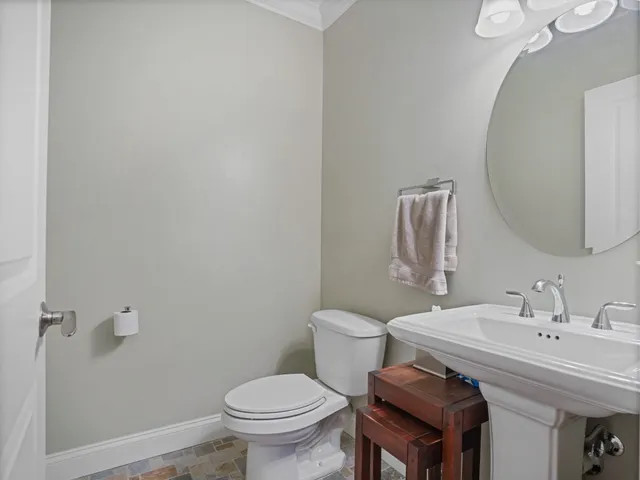 a bathroom with a sink toilet and mirror