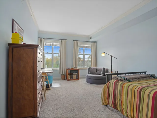 a bedroom with bed and balcony