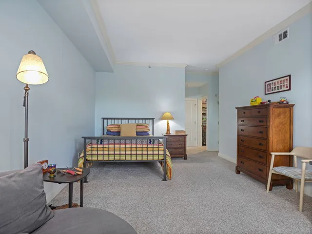 a bedroom with furniture and a lamp
