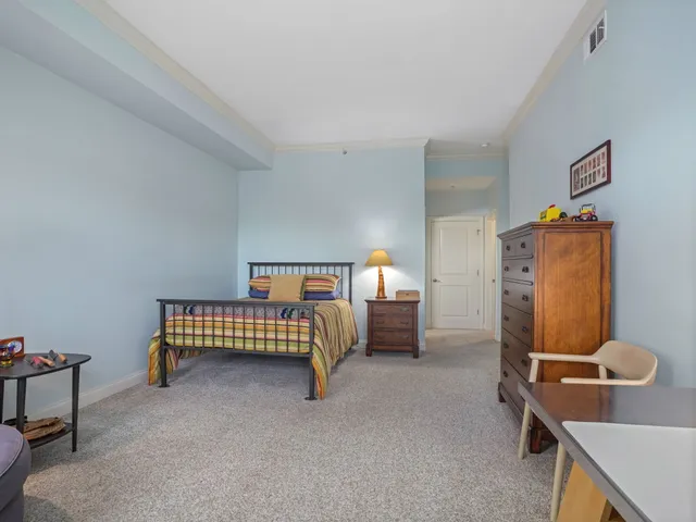 a bedroom with furniture and a window