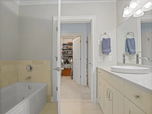 a bathroom with a tub sink and mirror