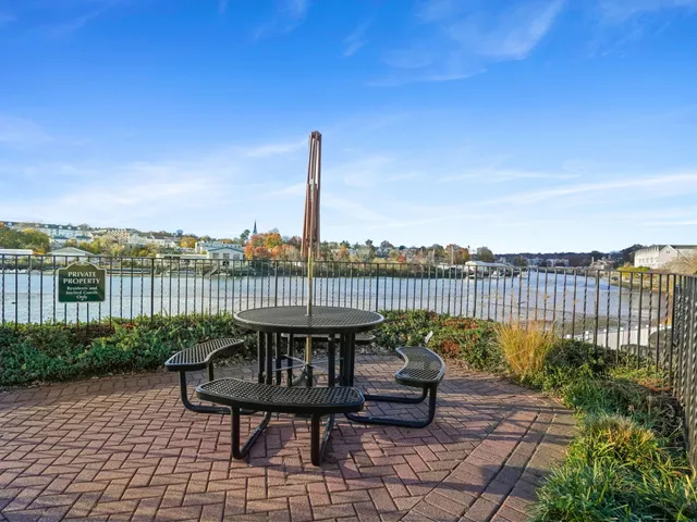 a view of a roof deck with table and chairs a barbeque with wooden fence