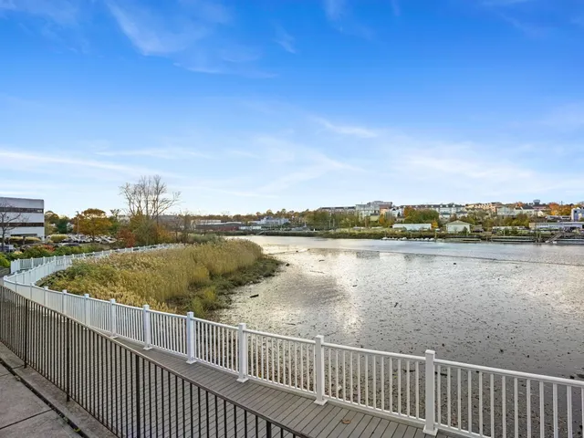 a view of a lake with a city from a balcony