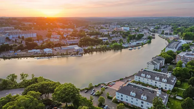 an aerial view of a city with lake view in back
