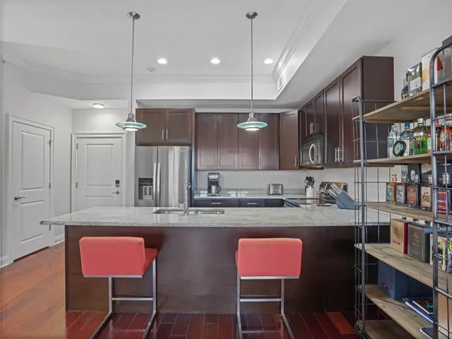 a kitchen with cabinets a sink and chairs