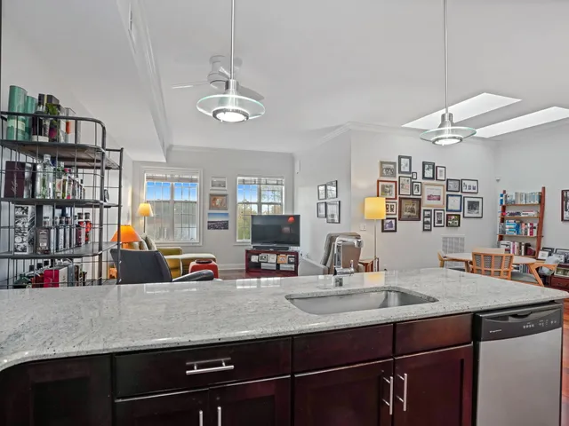 a kitchen with a counter space a sink and cabinets