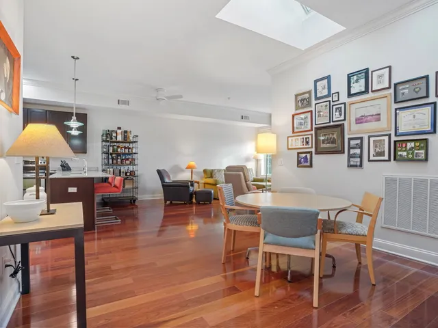 a dining room with furniture and wooden floor