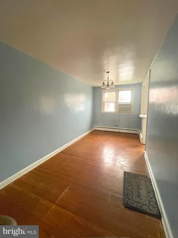 an empty room with floor to ceiling windows