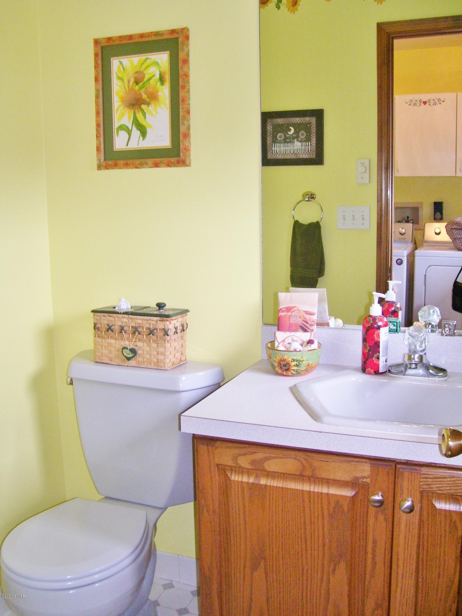 50 Layton Road Waymart, PA 18472 - Photo 26 of 61 a bathroom with a sink mirror vanity and toilet
