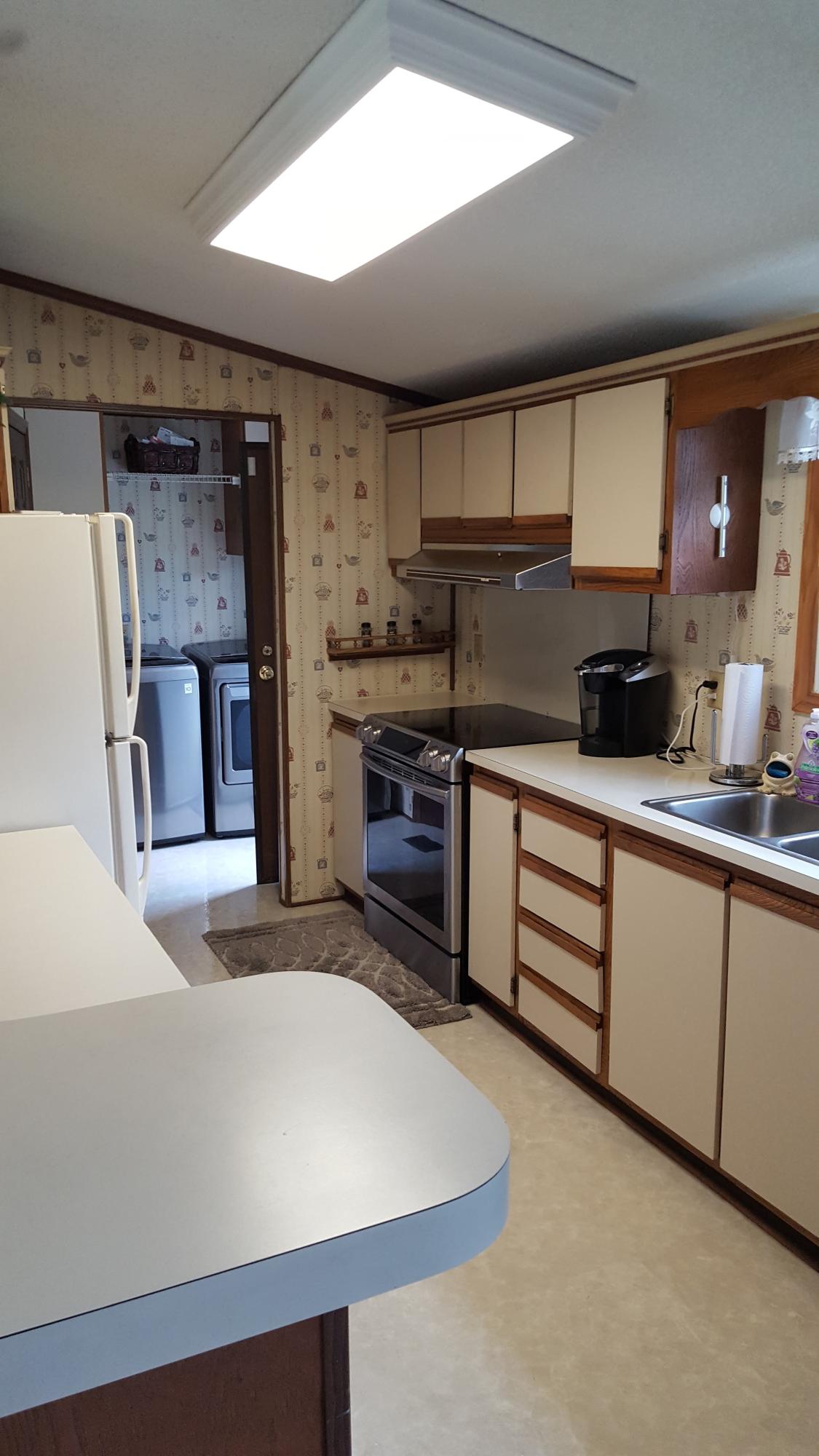 2771 Rutrough Road Southeast Roanoke, VA 24014 - Photo 12 of 31 a kitchen with stainless steel appliances a stove refrigerator sink and cabinets