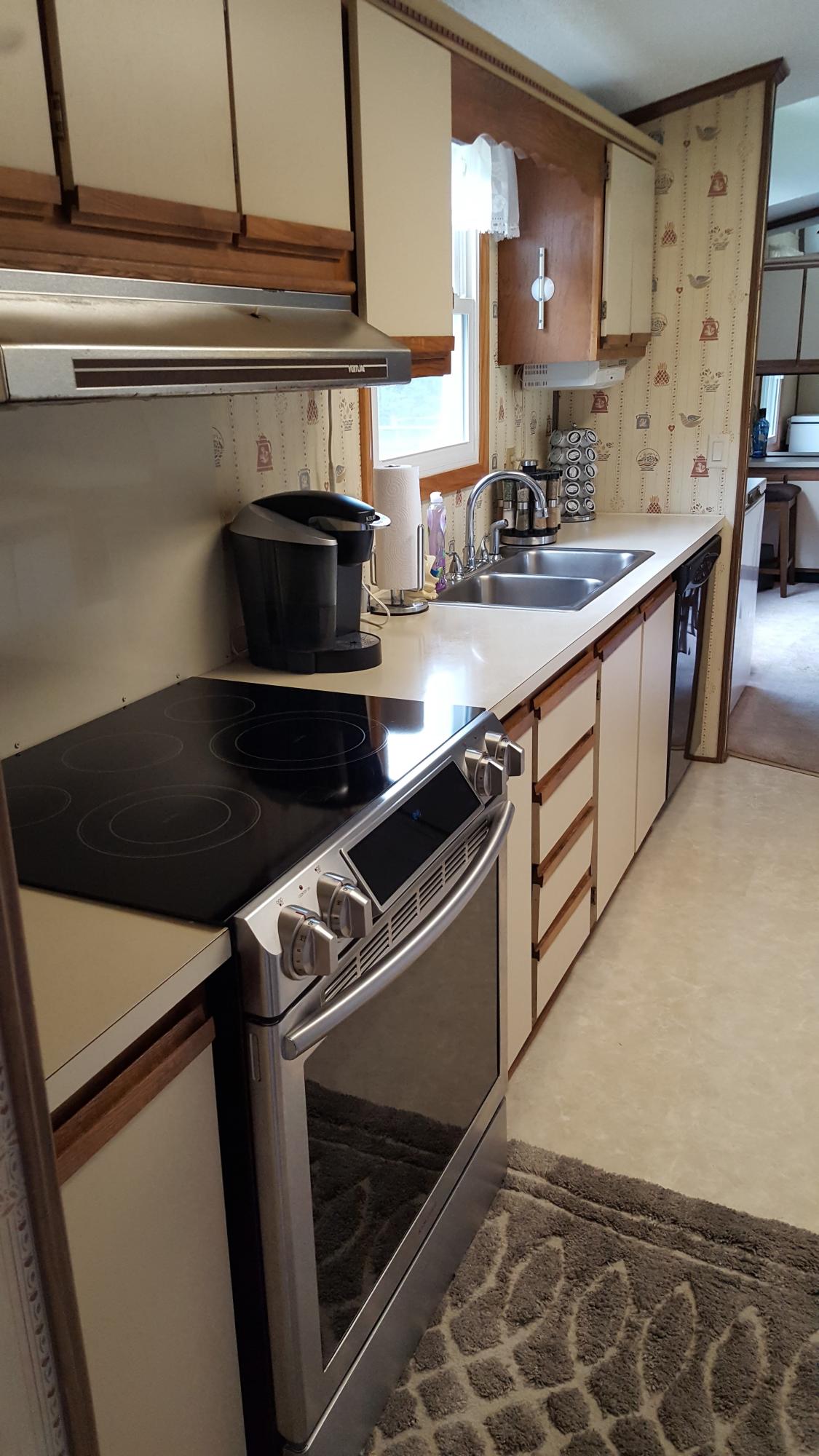 2771 Rutrough Road Southeast Roanoke, VA 24014 - Photo 17 of 31 a kitchen with granite countertop a stove and a sink
