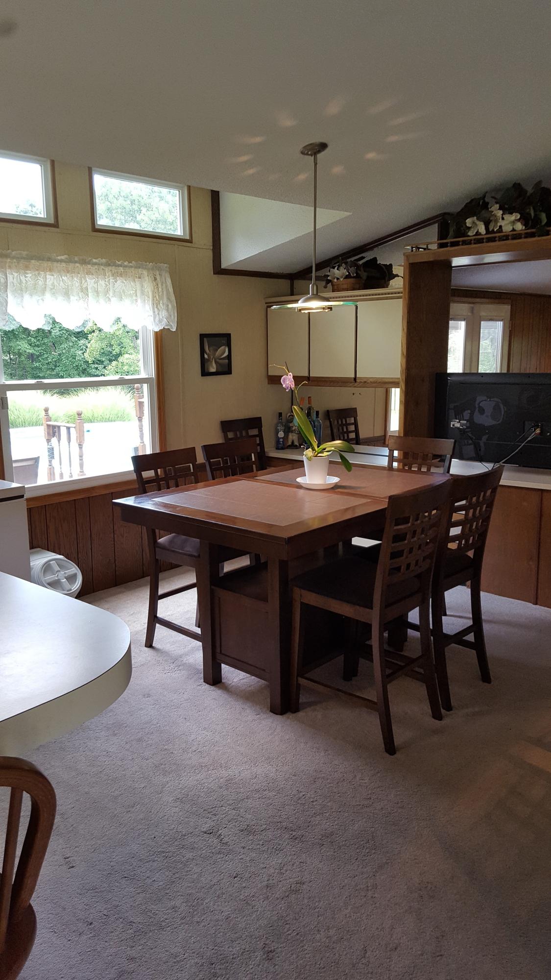 2771 Rutrough Road Southeast Roanoke, VA 24014 - Photo 6 of 31 a room with a table chairs and a large window